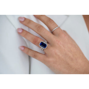 SOPHIA 6.5 Carat (13x8mm) Skinny Emerald Cut Lab Created Blue Sapphire Engagement Ring with Dainty Halo Setting in 14K White Gold